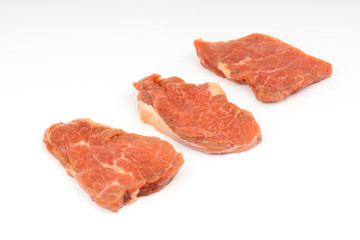 Fresh raw beef meat slices isolated over white background. Selective focus