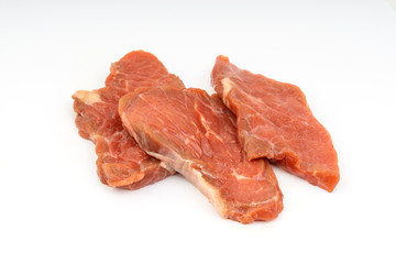 Fresh raw beef meat slices isolated over white background. Selective focus