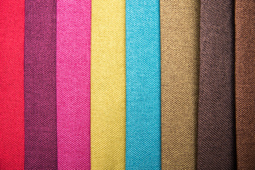 The fabrics of different colors are one by one. A beautiful colorful fabric texture