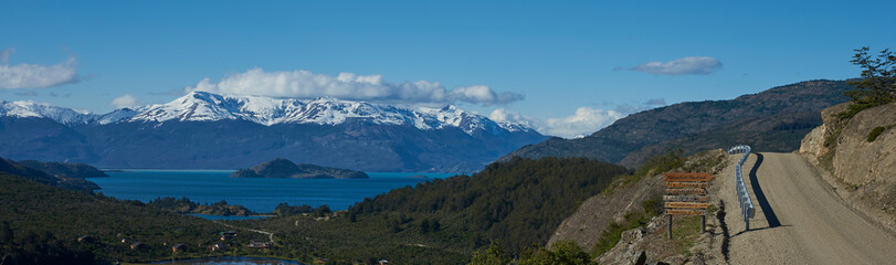 Naklejka na ściany i meble Landscape along the Carretera Austral next to the azure blue waters of Lago General Carrera in Patagonia, Chile. Lago Bertrand in the foreground.