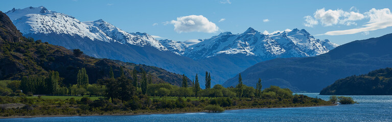 Fototapeta na wymiar Landscape along the Carretera Austral next to the azure blue waters of Lago General Carrera in Patagonia, Chile. Lago Bertrand in the foreground.