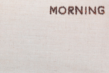 Morning letter sign from coffee beans isolated on linea texture, aligned top right.