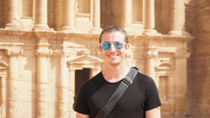 Tourist in front of the Monastery Temple of the Nabataean Kingdom in Petra, Jordan.