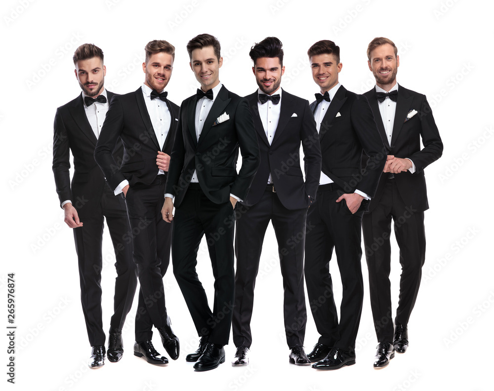 Poster group of elegant young men in tuxedos  standing together