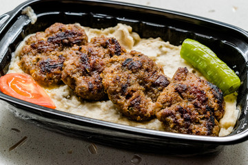 Turkish Fast Food Kofte / Kofta with Roasted Eggplant Hunkar Begendi in Plastic Cup / Container. (Aubergine Kebab or Kebap)