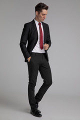 handsome man standing with hand in pocket while looking down