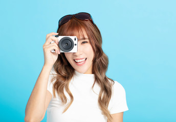 smiling young woman  holding with photo camera