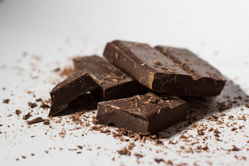 Chocolate on a white background falling dust cacao cocoa