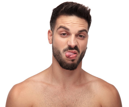 displeased undressed man being goofy with tongue out