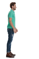 side view of man in green polo waiting in line