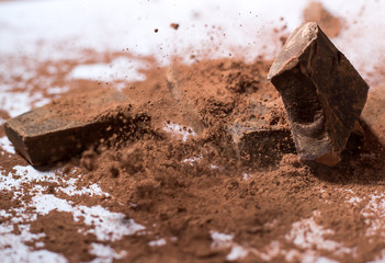 Chocolate on a white background falling dust cacao cocoa