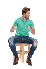 seated angry man wants to fight with fists