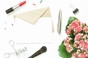 Female workspace with Kalanchoe flowering plant, Women's fashion accessories, stationery supplies and envelope on white background. Top view with copy space. Mock-up. - Image