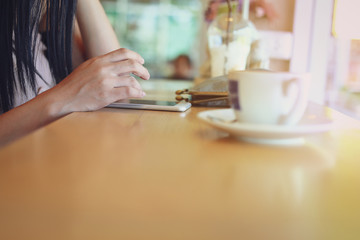 Fototapeta na wymiar female using mobile phone in coffee cafe