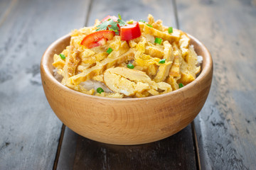Vegetable sliced omelet on a wood bowl ,Vegetarian omelet with fried tomatoes ,fresh sliced spring onions and spices on a burlap and on old wood background. Breakfast recipe