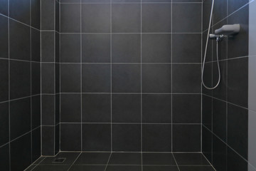 black tile wall and floor in bathroom