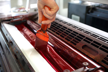 Printing machine. The printer applies ink inks. The printing process.