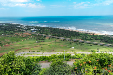 Fototapeta na wymiar top view of sea beach road looking awesome from top of a mountain with blue sky & beautiful sea view.