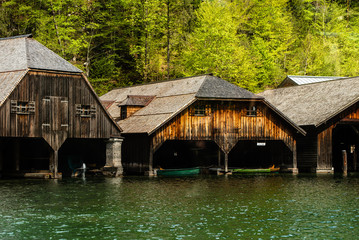 Picturesque bay and wooden docks for old ships that sail around Königssee, in Schönau, a Bavarian city surrounded by high Alps