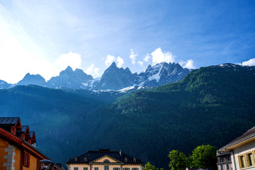 Fototapeta na wymiar Amazing scenery of the Alps from Chamonix France. Chamonix downtown in summer. Beautiful buildings on a sunny day of summer. Flowers, colorful facades.