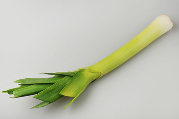 Young-green garlic, leek, isolated on gray background
