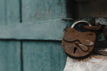 Old-fashioned rusty lock in the wooden door