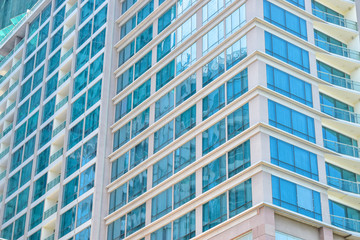 Wall of skyscraper with blue windows on corner
