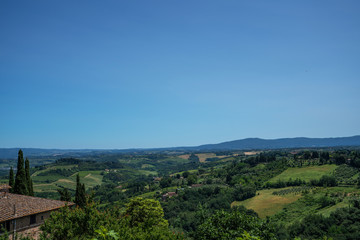 Fototapeta na wymiar Chianti region in summer season. View of countryside and Chianti vineyards from San Gimignano. Tuscany, Italy, Europe. Travel. Beautiful destination. Holiday outdoor vacation trip.