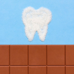 Stomatology concept. Teeth and sweets. Sugar destroys tooth enamel and leads to tooth decay, caries