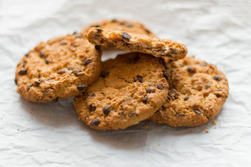 delicious oatmeal cookies with chocolate pieces on white paper