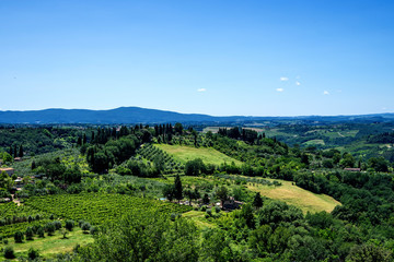 Chianti region in summer season. View of countryside and Chianti vineyards from San Gimignano. Tuscany, Italy, Europe. Travel. Beautiful destination. Holiday outdoor vacation trip.