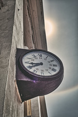 Old clock in sun and rainbow