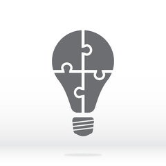 Simple icon light bulb puzzle in gray. Simple icon puzzle  from four pieces on gray background. Soft shadow. Vector illustration EPS10.