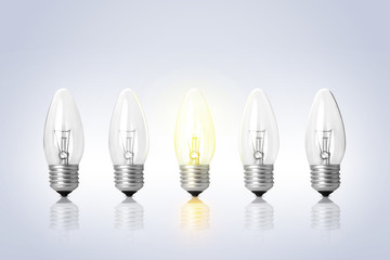 Many lamp bulbs on light background. Symbol of idea and solution