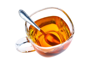 tea in transparent glass cup with spoon
