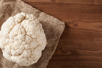 cauliflower over wooden table, vegetarian food 