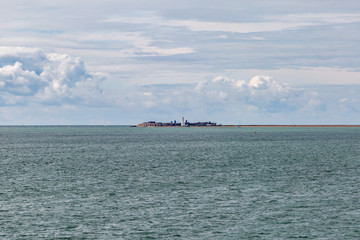 Looking out from a ferry across the water towards Hurst Spit, Hampshire