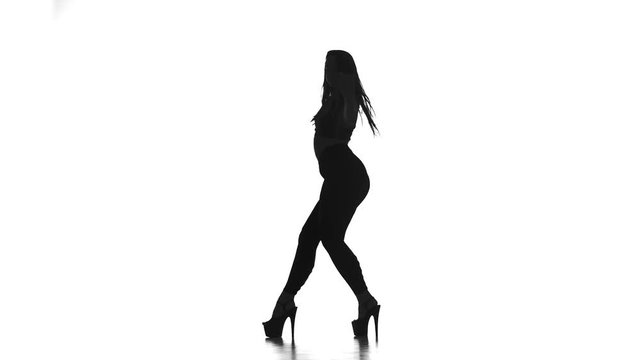 black silhouette on white background girl dancing modern dance, strip plastic