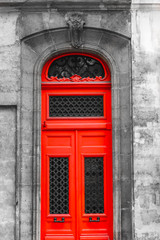 Fototapeta premium Old medieval red door is decorated cast iron forging ornament in Paris.