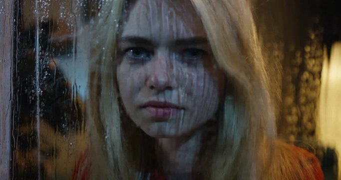 Young woman crying while watching storm