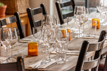 table set on dining table with wooden chairs.