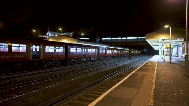 South Western Railways Train service stands at platform at night. London, UK