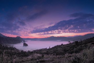 sunrise at Photo Corner View Point, Phu Langka, mountain view sea of fog in valley around with forest and the hills with red sky background, route 1148, Phayao, Thailand.