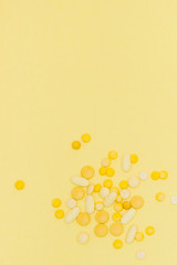 Pills on a yellow background. Design concept. Pills from a sunshine. Sunstroke. Summer diseases background. Copy space