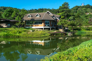Classic luxury house with water reflection, green garden and canal in Pilok old mining in E-Thong village, Pilok,Thong Pha Phum National Park