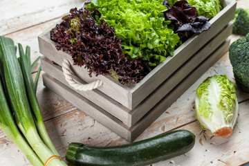 Fresh organic vegetables on rustic background