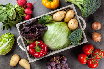 Fresh organic vegetables on rustic background