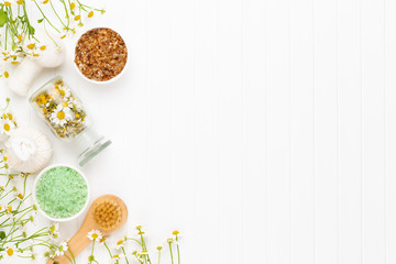 Spa still life with aromatherapy chamomile, herbal oil, soap, sea salt.