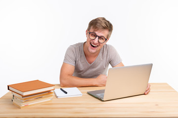 Study, education, people concept - man doing exercises in laptop, looking amazed
