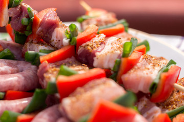 Close up pf delicious chicken breast on wooden skew with fresh vegetables, garlic, paprika fried on mangal barbeque grill and smoke
